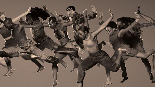 Dancers leaping in the air arms outstretched in celebration of the 55th Season
