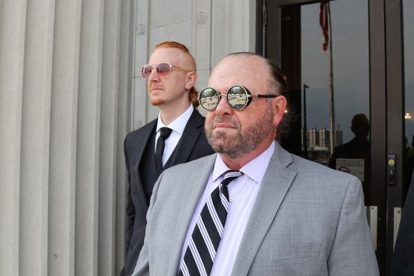 Pete Leehey and Jon Jansen, Iowa personal injury attorneys, leave a courthouse after winning a case.