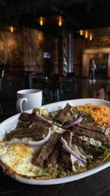 Chilaquiles verdes with steak and two eggs
