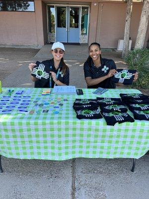 Coach Sarah & Coach Carissa passing out shirts to our campers