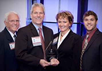 The Starr Group was awarded the BBB's Torch of Ethics Award in 2011. From left to right: Robert Starr, Tim and Mary Starr, and Nick Starr.