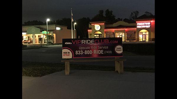 Night shot of new bus stop advertising for VIP Ride Club on 41, just south of Alico Road!