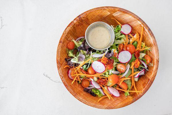 Chopped Salad
Baby Romaine, Tomatoes, Roasted Bell Peppers, Onions, Carrots, Cucumbers, Radish, Served with White Balsamic Vinaigrette.