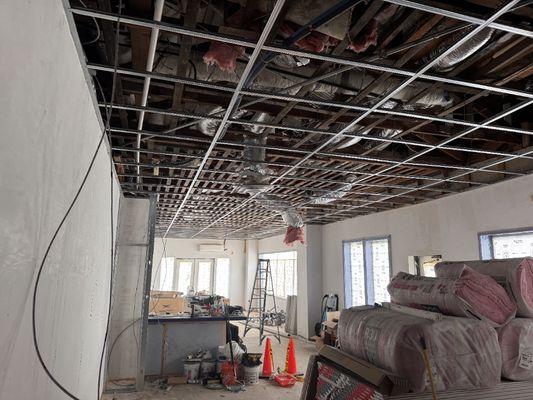 New drywall ceiling prior to drywall install. Skim coat walls and prime.