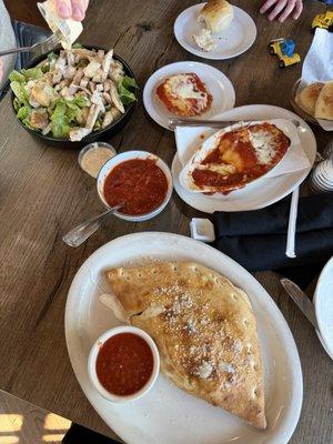 Calzone, kids ravioli, chicken Caesar salad