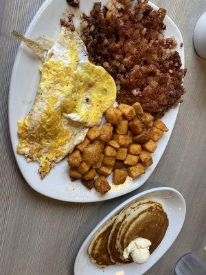 Corn, beef, hash with eggs, potato, and pancakes