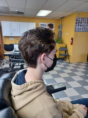 Man hair cut little long.