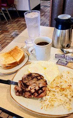 12/10/24 Grilled pork chop breakfast Over easy eggs hash browns sourdough toast cawfee