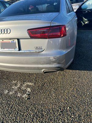 Scraped bumper with shuttle-bus-white paint.