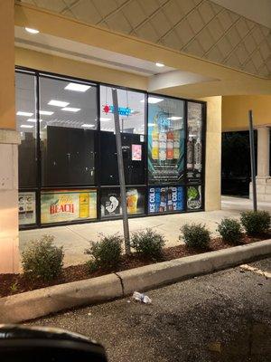 back of cold cases with sides blocking the warm cold cases with the warm liquor that is behind the soft drinks