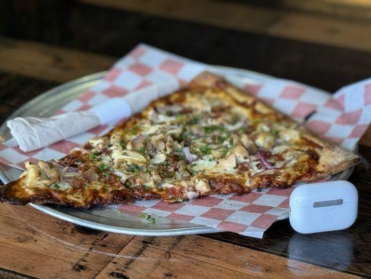 BBQ chicken pizza slice and AirPods Pro for size context.