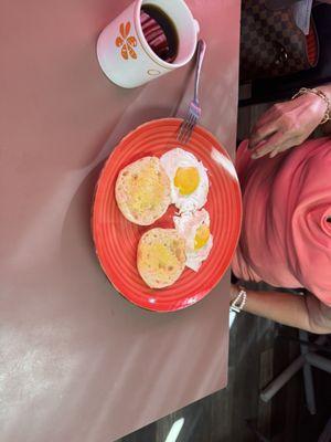 Two eggs sunny side up and English muffins