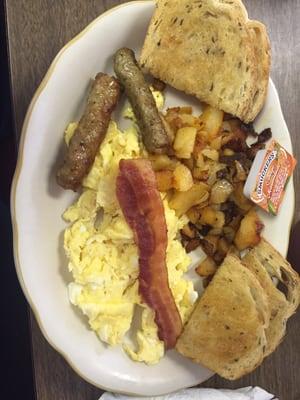 Big Breakfast- 3 eggs, bacon, sausage, toast, potatoes $8.95 ( I ate a piece of bacon already!)