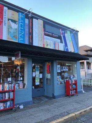 Front of the building with painted books up top.