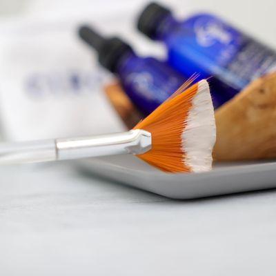 Fan brushes utilized for product application during facial services.