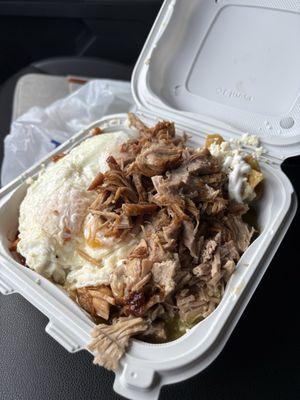 Chilaquiles divorciados with carnitas and over easy eggs