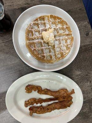 Waffle with infused strawberry butter, side of crispy bacon.