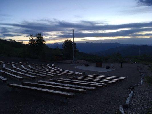 Amphitheater near the camp entrance for gatherings, meetings, and firesides, overlooking the Heber valley at dusk.