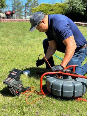 Luis scoping a customers sewer line.