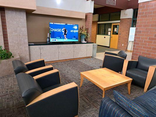 Inside lobby of Johnson Ranch Sports Club South - Large Screen TV set to US Open