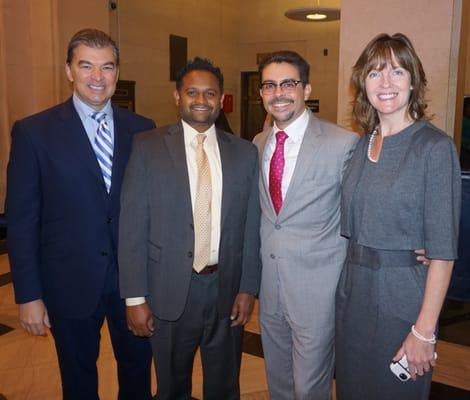 Patrick Parrotta (far left), Biju Koshy (center left), Hon. Raymond Rodriguez (center right), head court attorney Joanne Waters (far right).