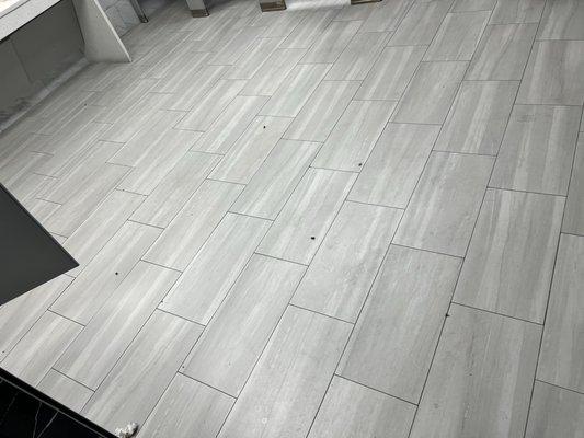 Bathroom with bugs and dirty toilet paper on the floor.