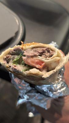 This is in the middle of the wrap. Basically only lavash with tahini sauce. Just very little meat. Not worth $15 at all.