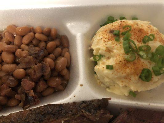Sides include beans and potato salad