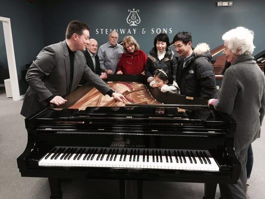 Paul showing off the inner workings of our beautiful Steinways!