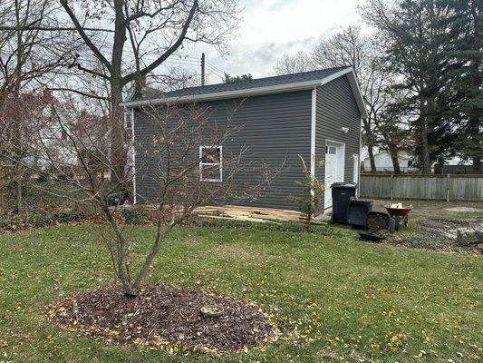 24x32 13 post frame garage with vinyl siding & shingle roof.