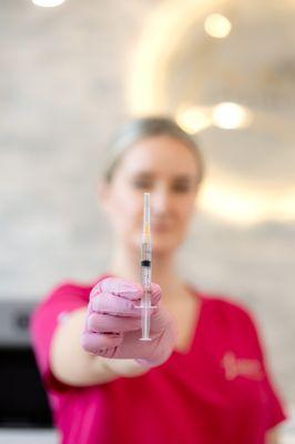 Nurse Injector holding up one of our B12 metabolism boosting shots