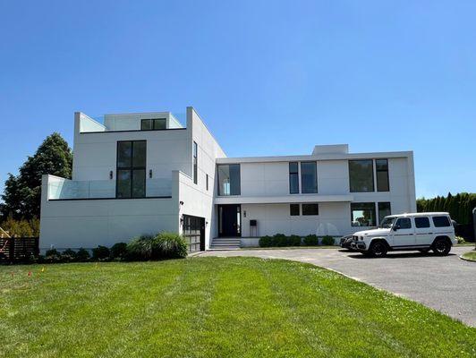 This waterfront property is a fully renovated open plan 1st floor with traditional stucco exterior finish with Marvin Modern windows.