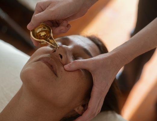 Nasya treatment with herbal ghee or oil.
