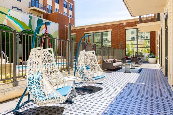 A patio with two chairs and a table.