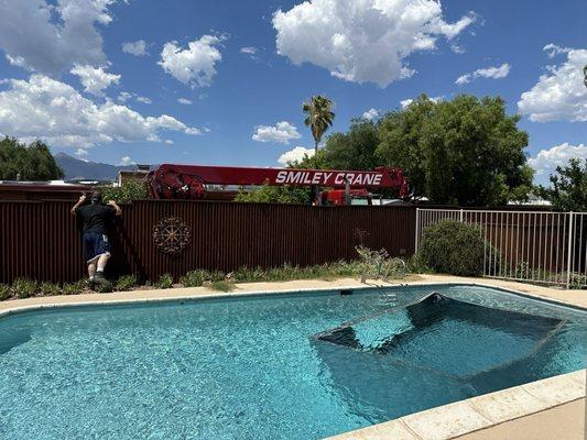 A micro burst put the neighbors shed in our pool. How to get it out without damaging the plaster? Smiley's crane did a great job!