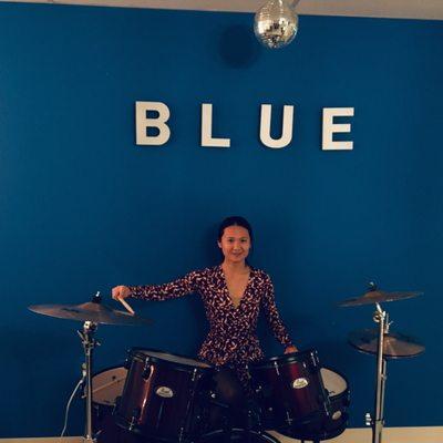 Wife showing off on the drums in reception area.