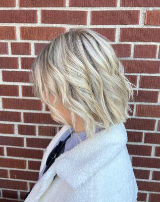 Short blunt icy blonde bob with a full head hilight.