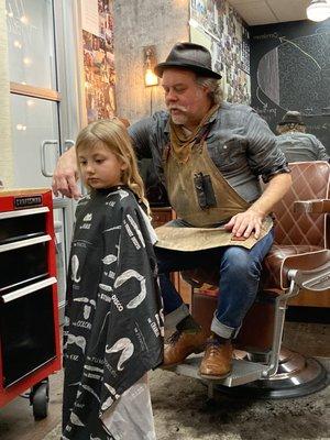 Holiday giving my daughter a haircut.