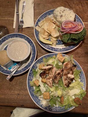 Burger at the top, chicken Caesar salad on the bottom and Caesar dressing on the left.