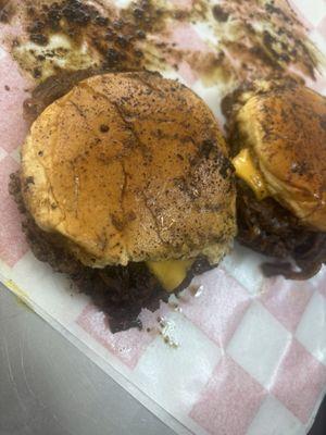 Our delicious slider smash burgers topped with freshly made caramelized onions, American cheese, pickles, mustard, and buttered buns