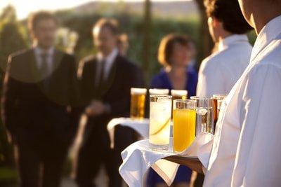 Tapuz Staffing_Phoenix, Arizona_Event Servers passing beverages at an outdoor daytime formal event