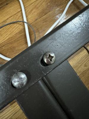 Two mismatched screws to hold floating frame in place