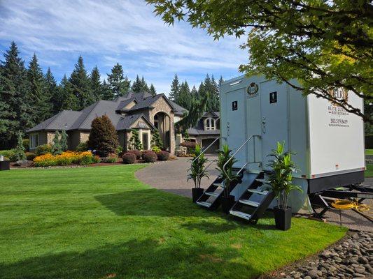 The perfect touch for a backyard wedding. This luxury restroom trailer blends seamlessly into outdoor spaces.