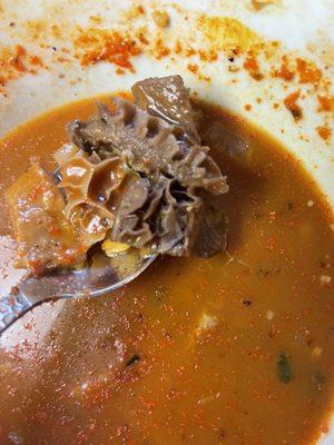 Dark over heated honey comb menudo meat.