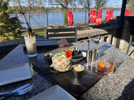 Crab tower and cocktails seated outside with a beautiful view and top notch service.