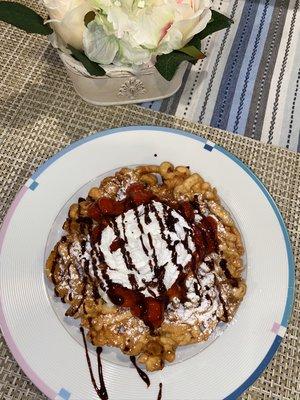 Funnel Cake with strawberries and chocolate syrup