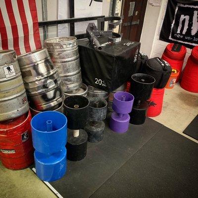 Kegs, sandbags, circus dumbbells.