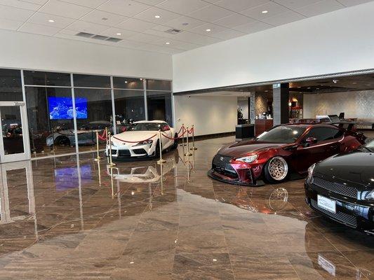 Shiny clean showroom floor. Coffee bar in background.