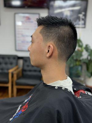 Slight combover with bald taper on the sides and back.