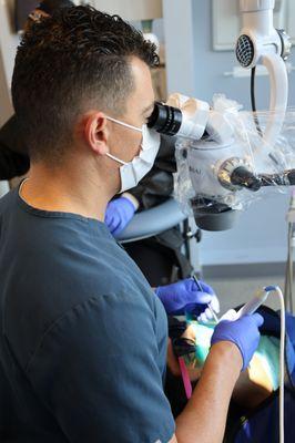 Dr. Marc Jiorle using Zeiss microscopes to perform treatment.